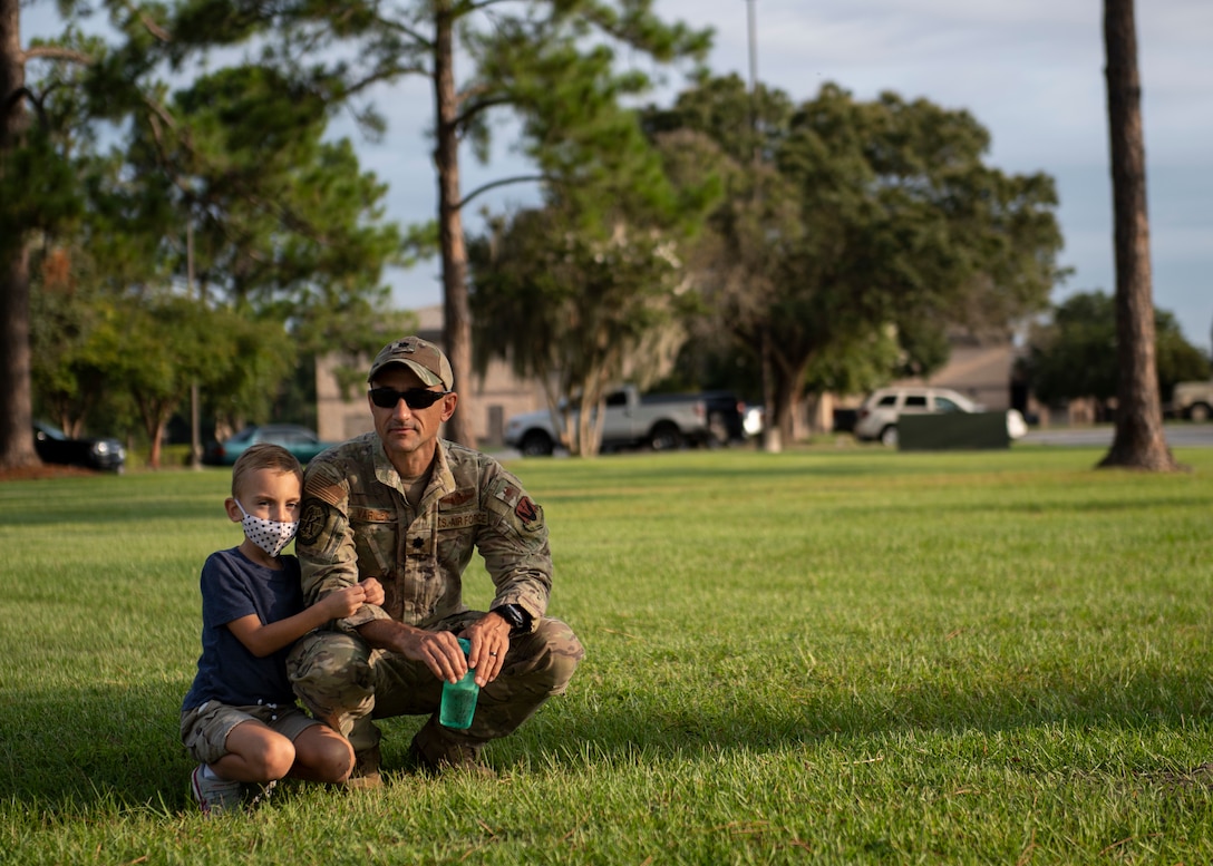A father and son wait for the ceremony