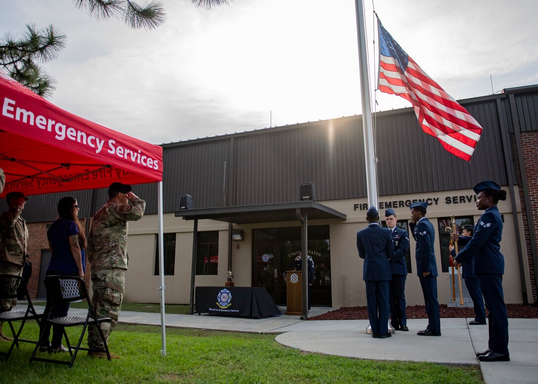 The honor guard lowers the flag to half staff