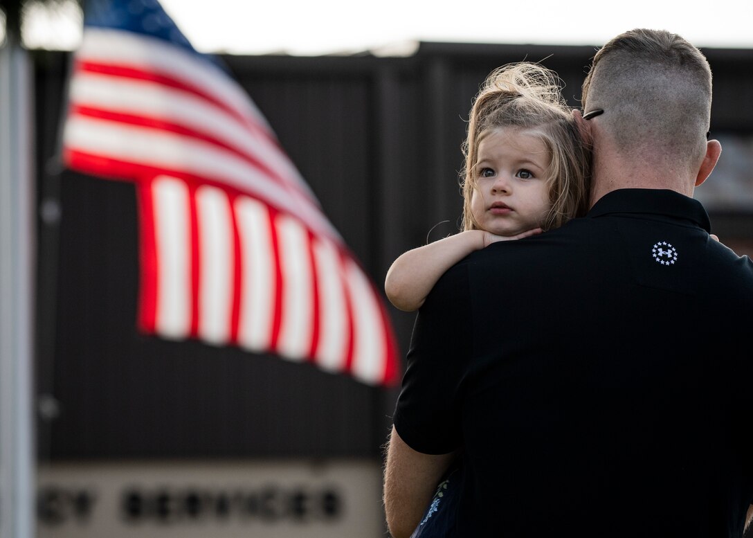 A father holds his daughter
