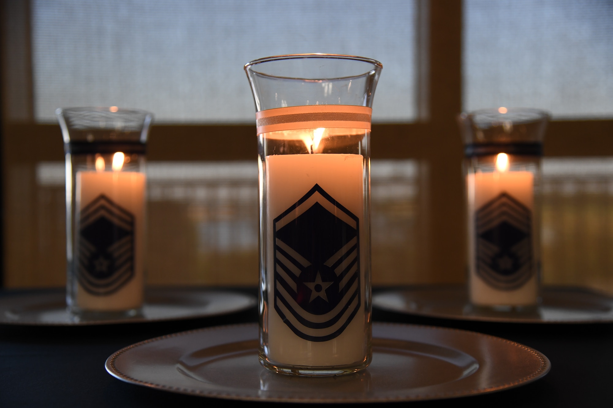 Candles are on display during the Senior NCO Induction Ceremony inside the Bay Breeze Event Center at Keesler Air Force Base, Mississippi, Sept. 10, 2021. More than thirty enlisted members were recognized during the event. (U.S. Air Force photo by Kemberly Groue)