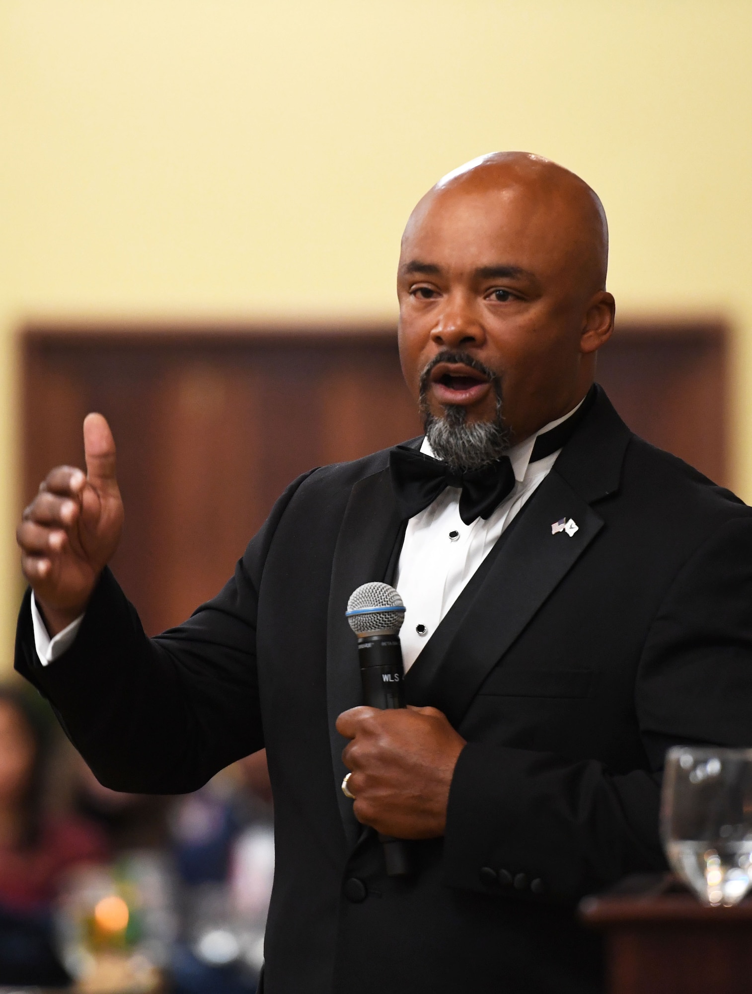 Retired Chief Master Sgt. Linus Jordan delivers remarks during the Senior NCO Induction Ceremony inside the Bay Breeze Event Center at Keesler Air Force Base, Mississippi, Sept. 10, 2021. More than thirty enlisted members were recognized during the event. (U.S. Air Force photo by Kemberly Groue)