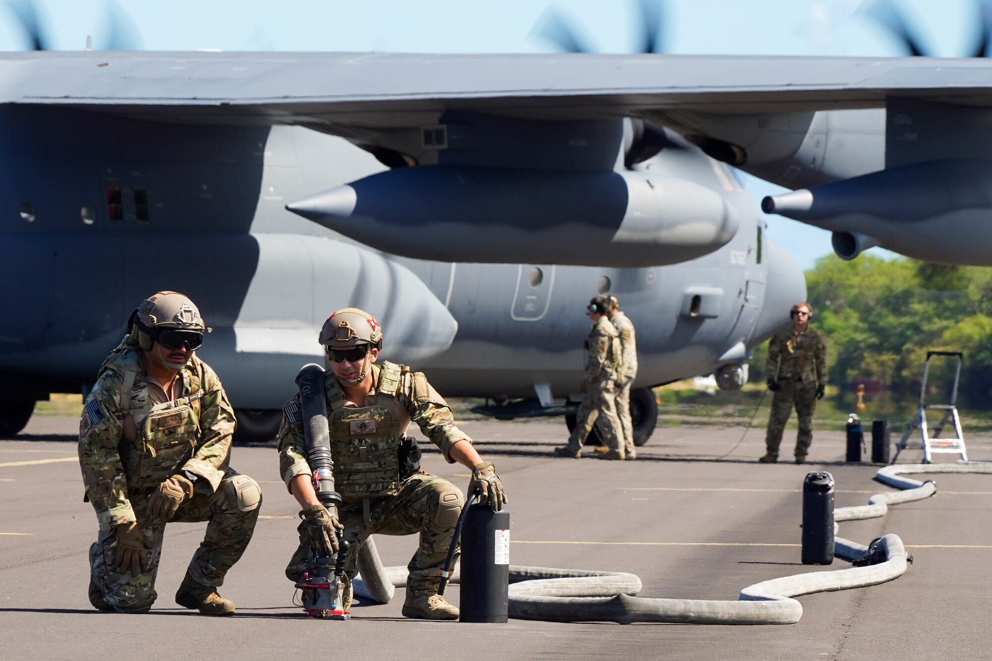Staff Sgt. John Guerrero, 353d Special Operations Group forward area refueling point team chief and Staff Sgt. Andrew Lozoya, 353d SOG, FARP team member, wait to refuel an F-22 Hawaiian Raptor during an Agile Combat Employment training exercise at Pacific Missile Range Facility Barking Sands, Hawaii, September 8, 2021. The FARP exercise prepares members for potential future operations during covert missions where traditional refueling capabilities are not feasible. (U.S. Air Force photo by Airman 1st Class Makensie Cooper)
