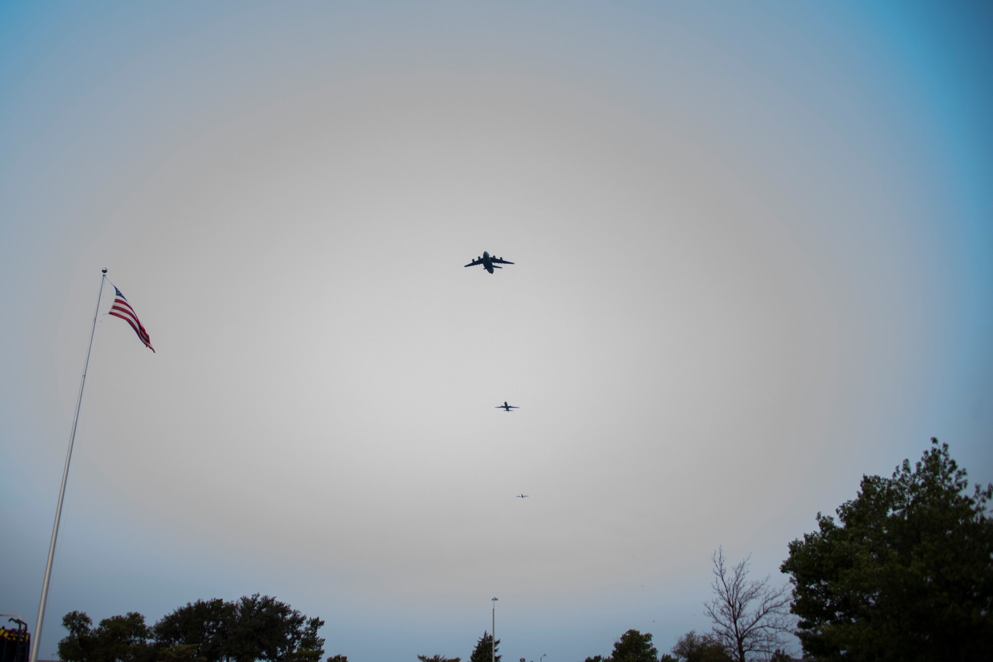 A C-17 Globemaster III, KC-135 Stratotanker, and KC-46 Pegasus fly over the 97th Air Mobility Wing (AMW) Remembrance Ceremony at Altus Air Force Base, Oklahoma, Sept. 11, 2021. This was the first time in 97th AMW history that all three aircraft flew over an event at the same time. (U.S. Air Force photo by Senior Airman Amanda Lovelace)