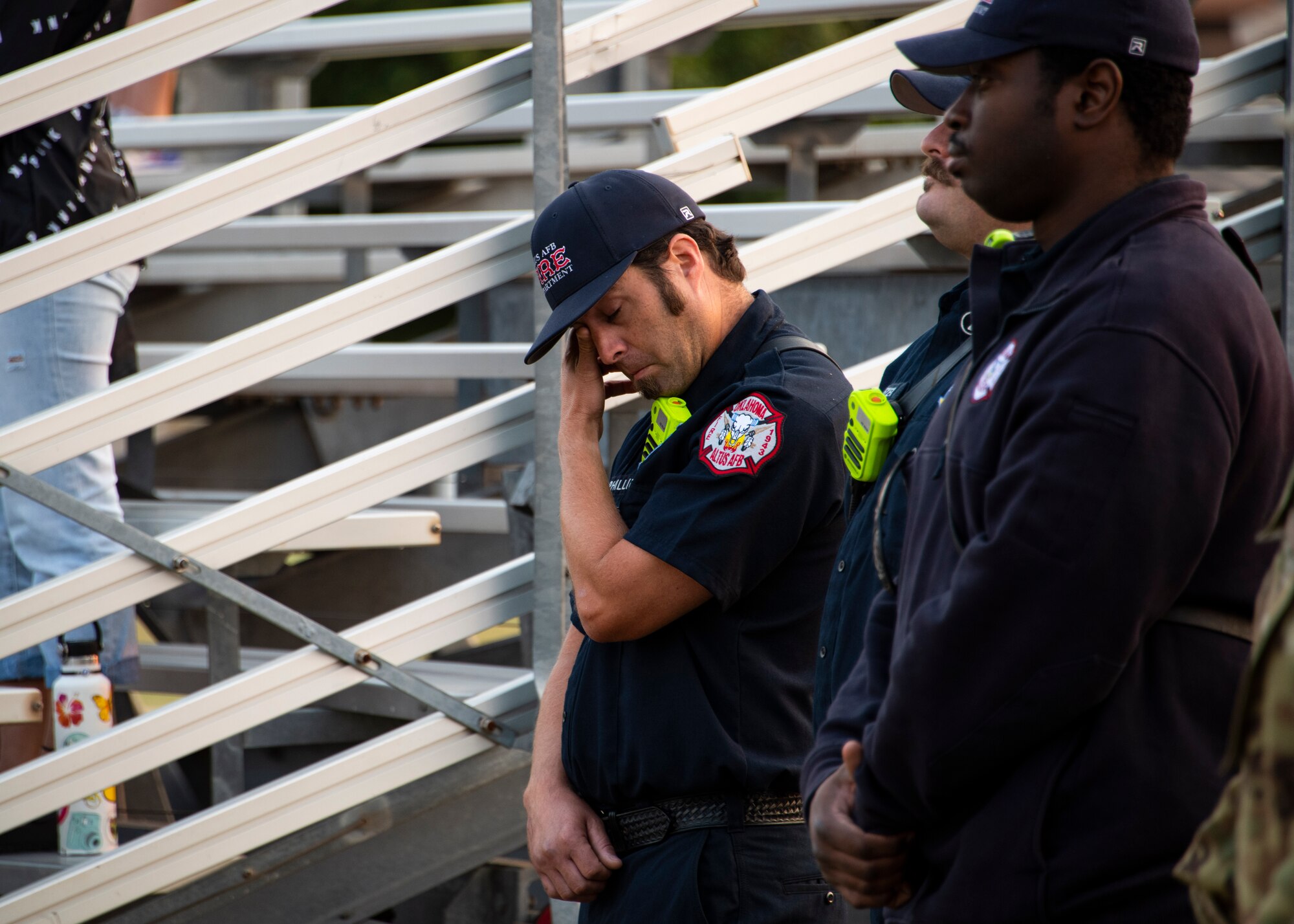 Josh Phillips, 97th Civil Engineer Squadron firefighter, left, wipes tears from his eyes as “Amazing Grace” plays during the 97th Air Mobility Wing Remembrance Ceremony at Altus Air Force Base, Oklahoma, Sept. 11, 2021. This year marks 20 years since the 9/11 attacks. (U.S. Air Force photo by Senior Airman Amanda Lovelace)