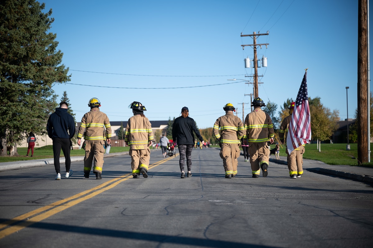 U.S. Air Force Airmen assigned to the 354th Fighter Wing and their families participate in a 9/11 remembrance 5k march on Eielson Air Force Base, Alaska, Sept. 11, 2021.