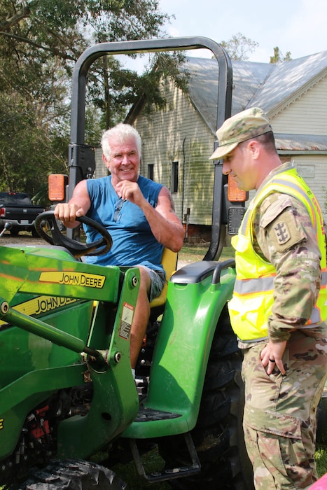 Capt. Aaron Miley from Honolulu District talks to a homeowner, Nathan Mitch of Donaldsonville, LA. Miley is in support of he Federal Emergency Management Agency (FEMA) assigned Temporary Emergency Power Mission as part of the U.S. Army Corps of Engineers Hurricane Recovery mission in southeastern Louisiana.