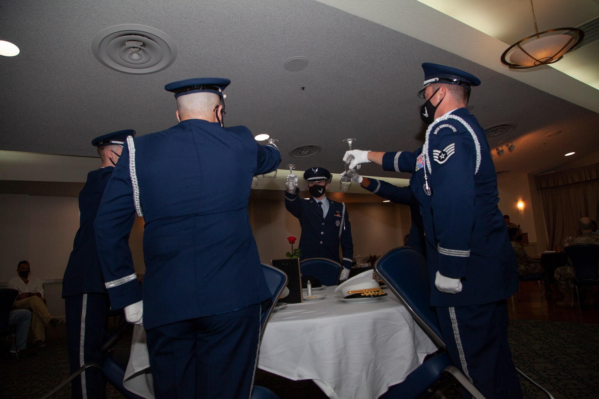 Members of the Blue Eagles Honor Guard turn glasses upside down as they perform the POW/MIA Table presentation during a POW/MIA Remembrance Ceremony and dinner at Edwards Air Force Base, Sept. 10. The inverted glass signifies a missing service member's inability to toast with those in attendance. (Air Force photo by Clay Cupit)