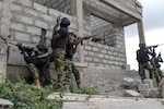 Special operators conduct an exercise in an old building.