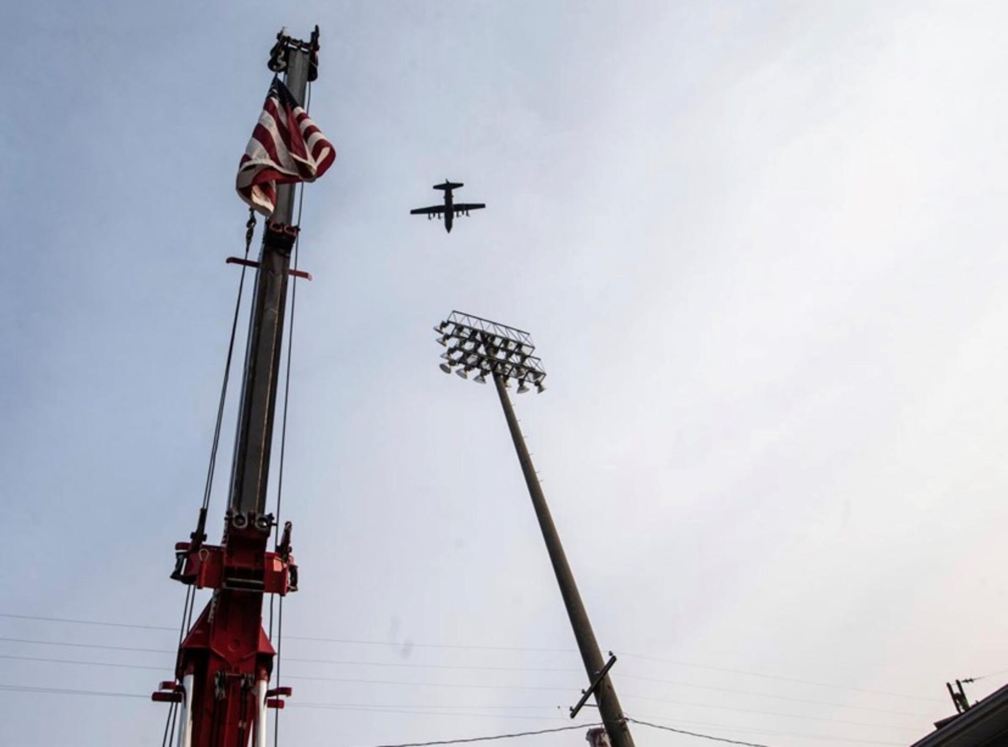 C-130 flies above the U.S. flag