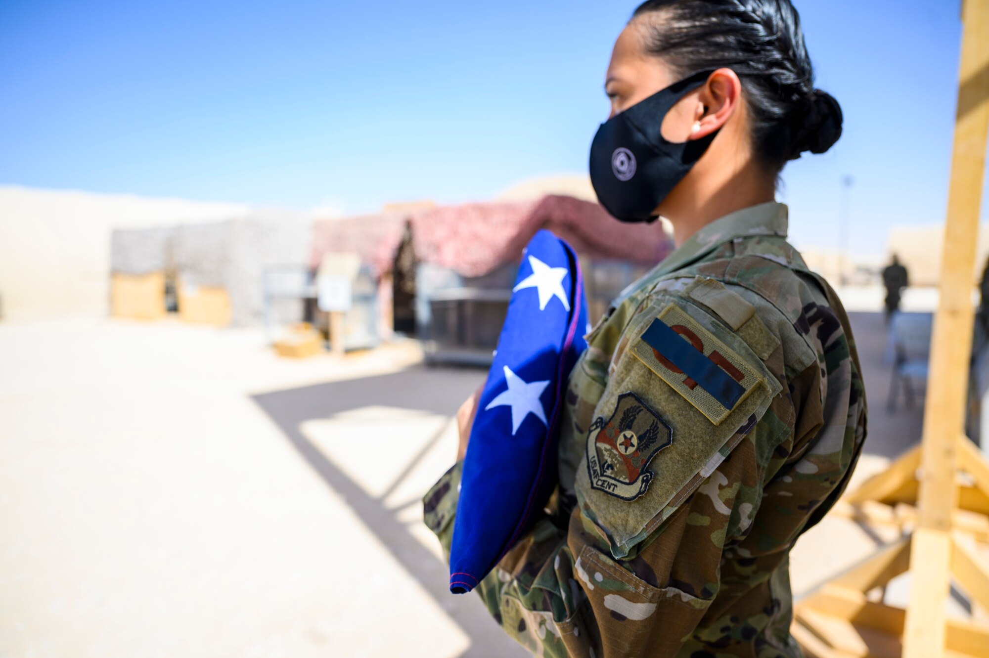 Staff Sgt. Aubrey Houston, 378th Expeditionary Security Forces Squadron defender, holds the flag during a Remembrance Ceremony Sept. 11, 2021, at Prince Sultan Air Base, Kingdom of Saudi Arabia.