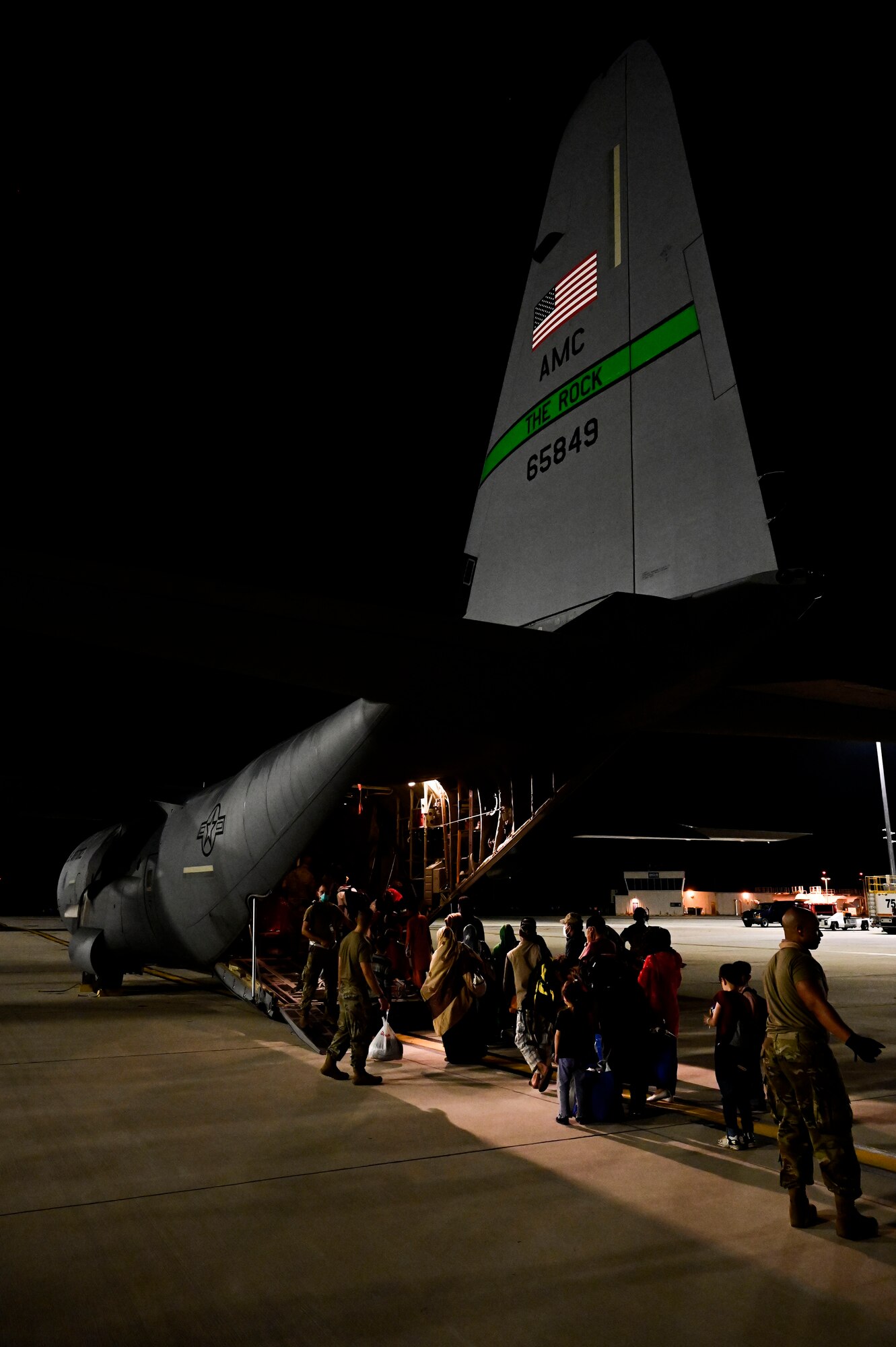 Afghan evacuees board a C-130J