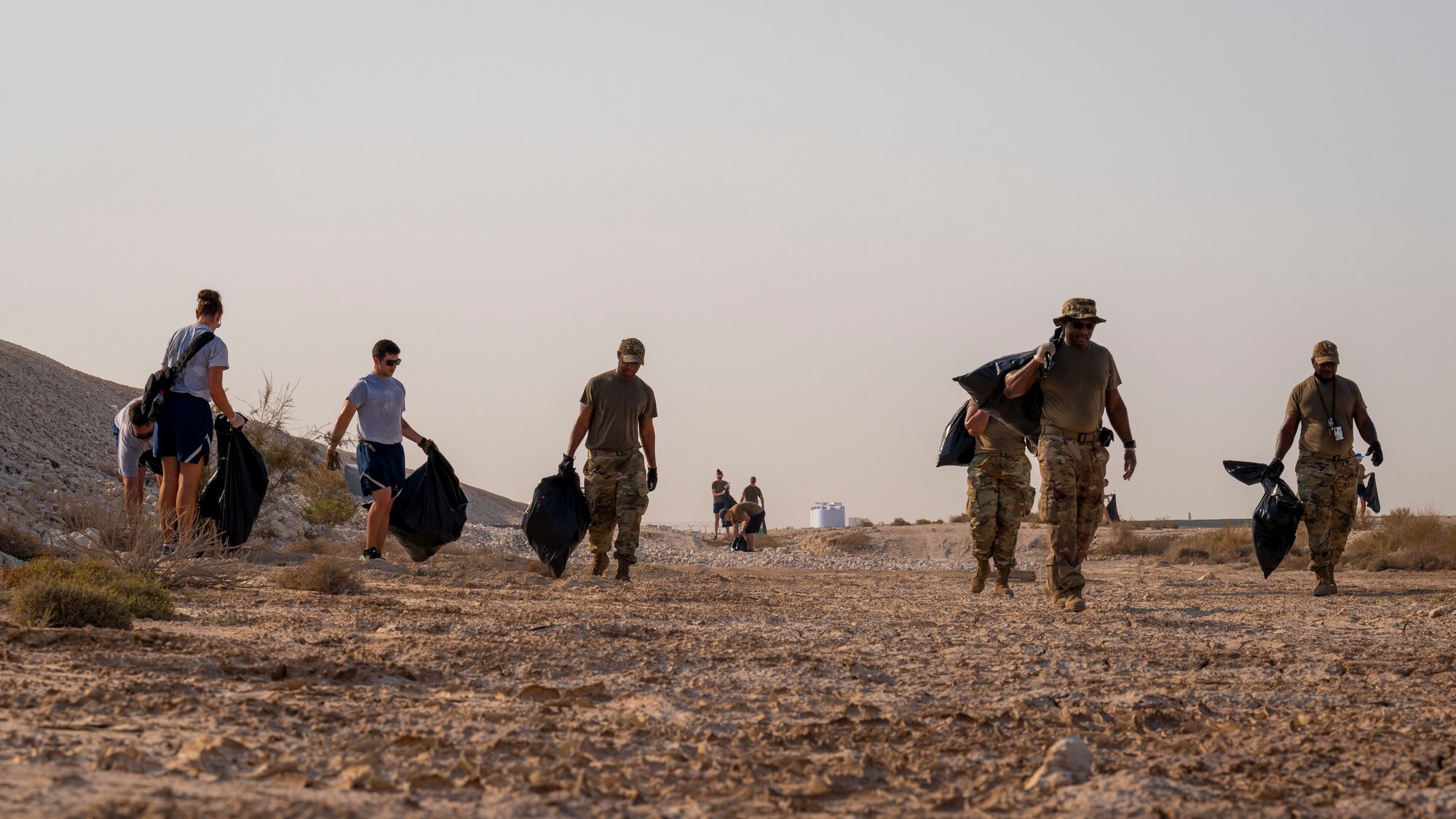 Service members walk along the flightline, Sept. 08, 2021, at Al Udeid Air Base, Qatar.