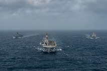 ARABIAN SEA (September 13, 2021) Amphibious assault ship USS Essex (LHD 2), middle, amphibious dock landing ship USS Pearl Harbor (LSD 52), left, and amphibious transport dock ship USS Portland (LPD 27), transit the Arabian Sea, Sept. 13. The Essex Amphibious Ready Group is deployed to the U.S. 5th Fleet area of operations to ensure maritime stability and security in the Central Region, connecting the Mediterranean and the Pacific through the western Indian Ocean and three strategic choke points.