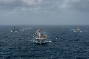 ARABIAN SEA (September 13, 2021) Amphibious assault ship USS Essex (LHD 2), middle, amphibious dock landing ship USS Pearl Harbor (LSD 52), left, and amphibious transport dock ship USS Portland (LPD 27), transit the Arabian Sea, Sept. 13. The Essex Amphibious Ready Group is deployed to the U.S. 5th Fleet area of operations to ensure maritime stability and security in the Central Region, connecting the Mediterranean and the Pacific through the western Indian Ocean and three strategic choke points.