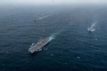 ARABIAN SEA (September 13, 2021) Amphibious assault ship USS Essex (LHD 2), middle, amphibious dock landing ship USS Pearl Harbor (LSD 52), left, and amphibious transport dock ship USS Portland (LPD 27), transit the Arabian Sea, Sept. 13. The Essex Amphibious Ready Group is deployed to the U.S. 5th Fleet area of operations to ensure maritime stability and security in the Central Region, connecting the Mediterranean and the Pacific through the western Indian Ocean and three strategic choke points.