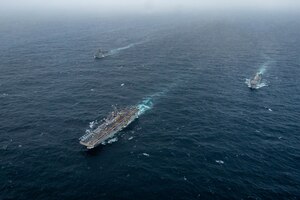 ARABIAN SEA (September 13, 2021) Amphibious assault ship USS Essex (LHD 2), middle, amphibious dock landing ship USS Pearl Harbor (LSD 52), left, and amphibious transport dock ship USS Portland (LPD 27), transit the Arabian Sea, Sept. 13. The Essex Amphibious Ready Group is deployed to the U.S. 5th Fleet area of operations to ensure maritime stability and security in the Central Region, connecting the Mediterranean and the Pacific through the western Indian Ocean and three strategic choke points.