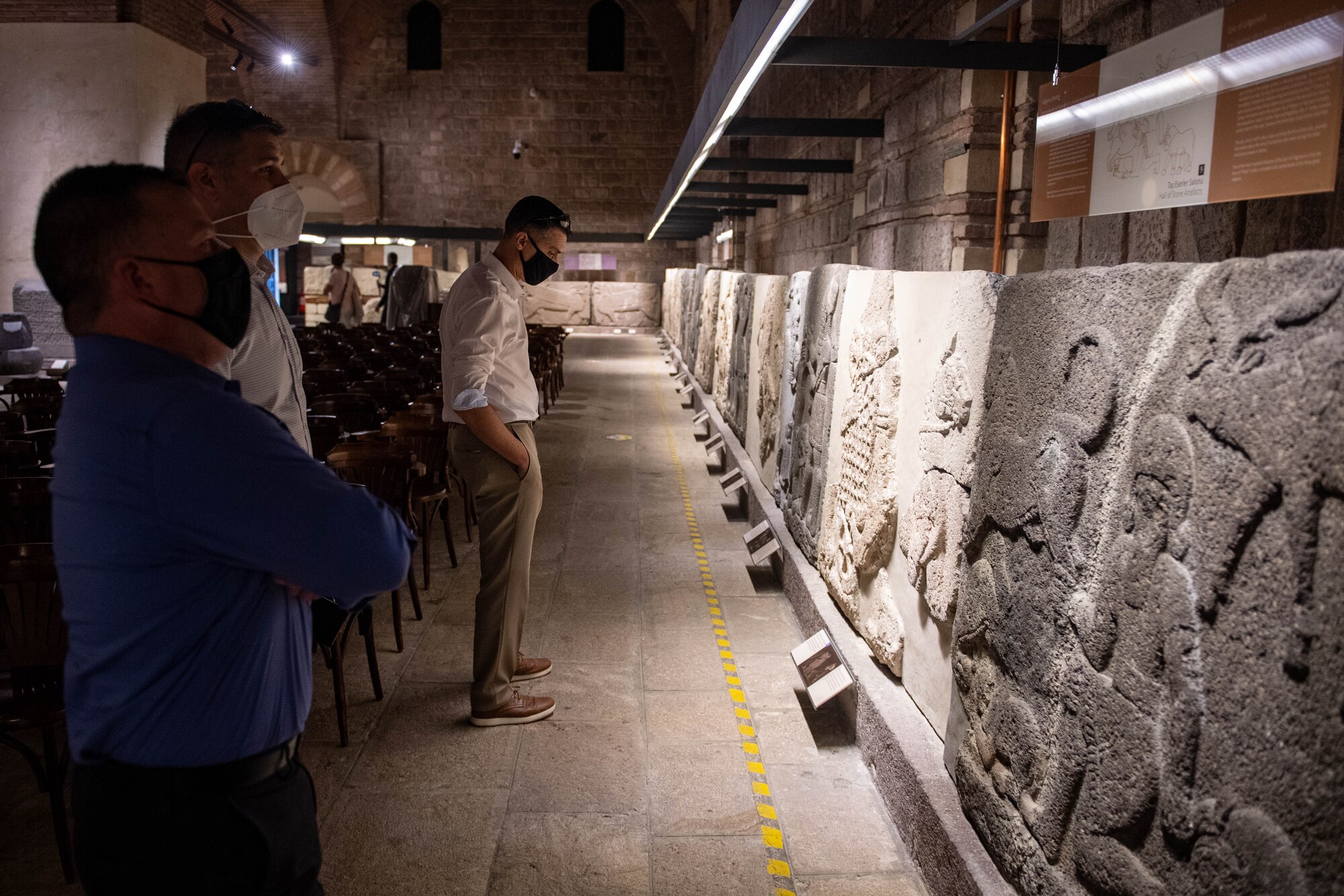 Three officers looking at artifacts