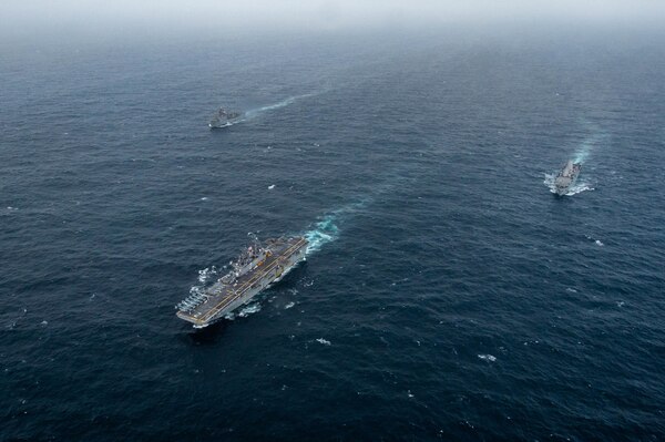 USS Essex (LHD 2), middle, USS Pearl Harbor (LSD 52), left, and USS Portland (LPD 27) transit the Arabian Sea.