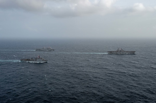 ARABIAN SEA (September 13, 2021) Amphibious assault ship USS Essex (LHD 2), right, amphibious dock landing ship USS Pearl Harbor (LSD 52), front, and amphibious transport dock ship USS Portland (LPD 27), transit the Arabian Sea, Sept. 13. The Essex Amphibious Ready Group is deployed to the U.S. 5th Fleet area of operations to ensure maritime stability and security in the Central Region, connecting the Mediterranean and the Pacific through the western Indian Ocean and three strategic choke points.
