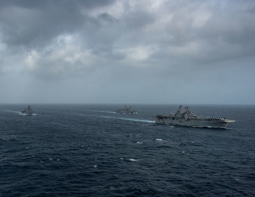 ARABIAN SEA (September 13, 2021) Amphibious assault ship USS Essex (LHD 2), right, amphibious dock landing ship USS Pearl Harbor (LSD 52), left, and amphibious transport dock ship USS Portland (LPD 27), transit the Arabian Sea, Sept. 13. The Essex Amphibious Ready Group is deployed to the U.S. 5th Fleet area of operations to ensure maritime stability and security in the Central Region, connecting the Mediterranean and the Pacific through the western Indian Ocean and three strategic choke points.