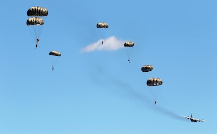 Soldiers with the 294th Quartermaster Company, 338th Quartermaster Company, Texas Army National Guard, the 3rd Special Forces Group, soldiers with the Latvian Army’s Special Forces Group and British Army’s 4th Battalion, Parachute Regiment (4 PARA), jump out of a C-130 Hercules aircraft over Camp Grayling Joint Maneuver Training Center, Grayling, Michigan, Aug. 13, 2021. The service members conducted joint airborne training during Northern Strike 21.