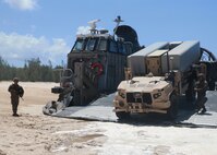 Artillery Marines from 1st Battalion, 12th Marines escort a Navy/Marine Corps Expeditionary Ship Interdiction System launcher vehicle ashore aboard Pacific Missile Range Facility Barking Sands, Hawaii, Aug. 16, 2021. The Marines of 1/12 struck a naval target ship Aug. 15, 2021, with two Naval Strike Missiles, which flew 100 nautical miles away before finding their mark. The Marine Corps’ primary modernization priority in support of Force Design 2030 is fulfilling the requirement for a ground-based anti-ship missile capability. NMESIS is the Marine Corps’ first solution meeting this requirement. (U.S. Marine Corps photo by Cpl. Luke Cohen, released)