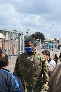 Airman speaking to evacuees,