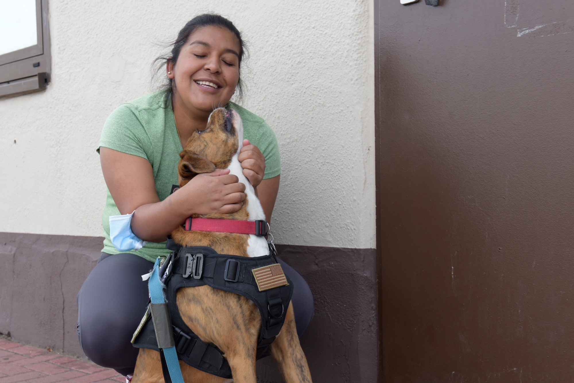 Dog handler holds her dog.