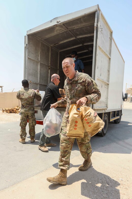 Zack Bazzi, the regional director in the Middle East and Central Asia for the non-profit organization, Spirit of America, helps stack boxes of donated goods at Camp As Sayliyah, Qatar, September 5, 2021. Soldiers continue to support Department of Defense and Department of State teammates in Afghanistan evacuation efforts with care and compassion at various U.S. Central Command locations. (U.S. Army photo by Spc. Elizabeth Hackbarth, U.S. Army Central Public Affairs)