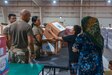 Zack Bazzi, the regional director in the Middle East and Central Asia for the non-profit organization, Spirit of America, helps stack boxes of donated goods at Camp As Sayliyah, Qatar, September 5, 2021. Soldiers continue to support Department of Defense and Department of State teammates in Afghanistan evacuation efforts with care and compassion at various U.S. Central Command locations. (U.S. Army photo by Spc. Elizabeth Hackbarth, U.S. Army Central Public Affairs)