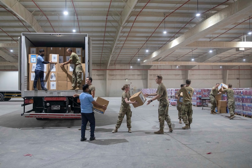 Zack Bazzi, the regional director in the Middle East and Central Asia for the non-profit organization, Spirit of America, helps stack boxes of donated goods at Camp As Sayliyah, Qatar, September 5, 2021. Soldiers continue to support Department of Defense and Department of State teammates in Afghanistan evacuation efforts with care and compassion at various U.S. Central Command locations. (U.S. Army photo by Spc. Elizabeth Hackbarth, U.S. Army Central Public Affairs)