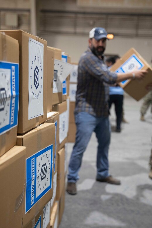 Zack Bazzi, the regional director in the Middle East and Central Asia for the non-profit organization, Spirit of America, helps stack boxes of donated goods at Camp As Sayliyah, Qatar, September 5, 2021. Soldiers continue to support Department of Defense and Department of State teammates in Afghanistan evacuation efforts with care and compassion at various U.S. Central Command locations. (U.S. Army photo by Spc. Elizabeth Hackbarth, U.S. Army Central Public Affairs)