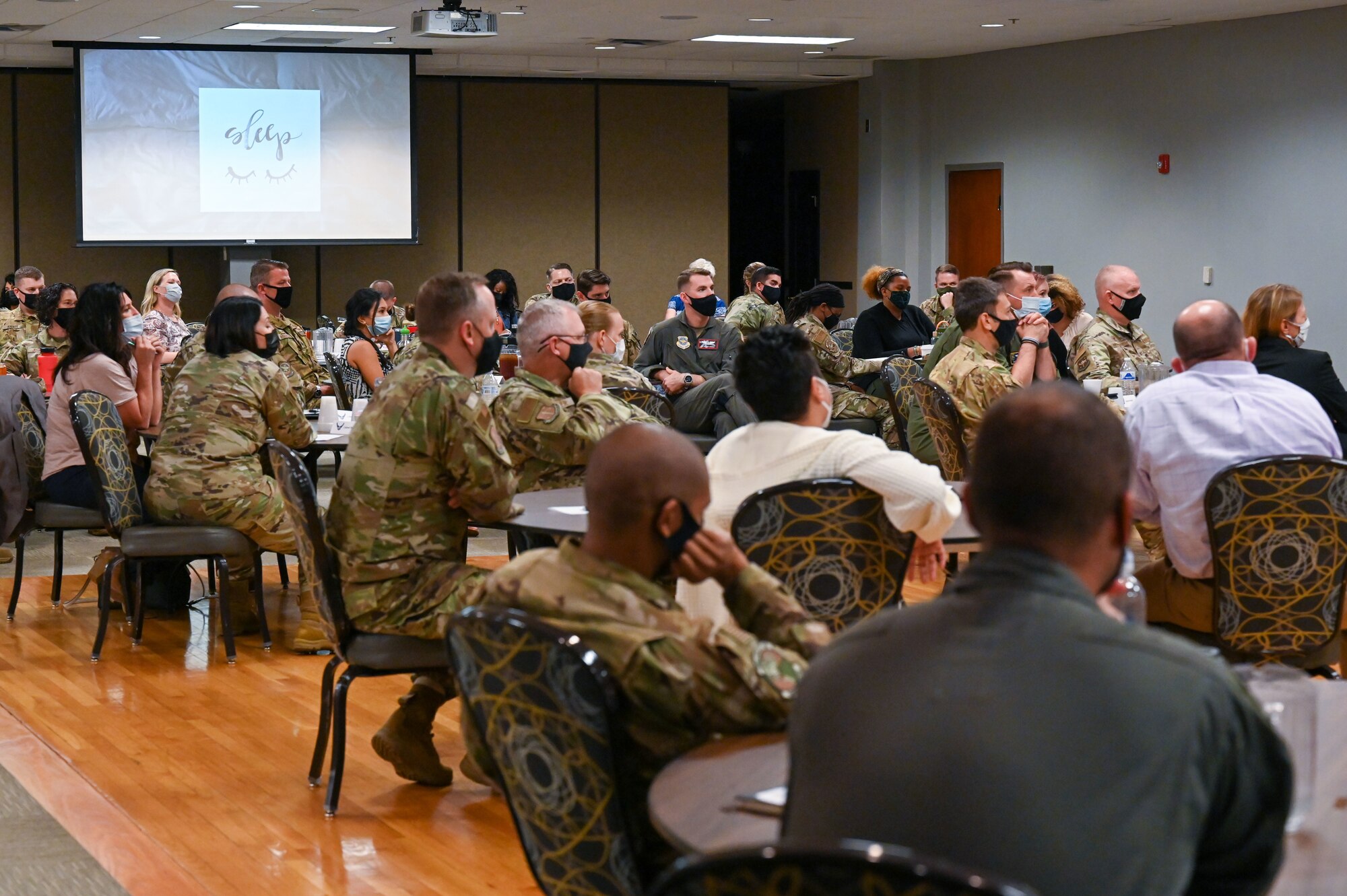 A group of people listen to a presentation