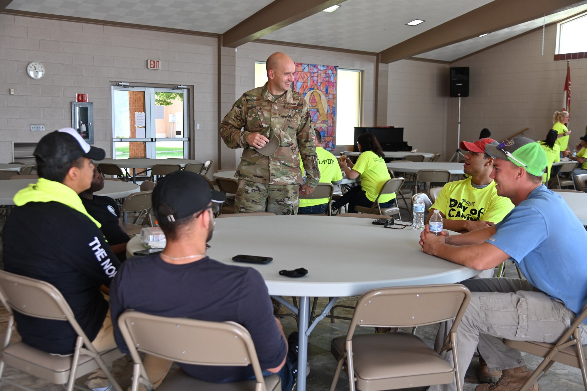 Col. Ryan Keeney, 49th Wing commander, speaks with Day of Caring volunteers, Sept. 10, 2021, at Alamogordo, New Mexico. In the 30-year history of Day of Caring in Alamogordo, Holloman has supported and participated in the event for the last 19 years. (U.S. Air Force photo by Airman 1st Class Jessica Sanchez-Chen)