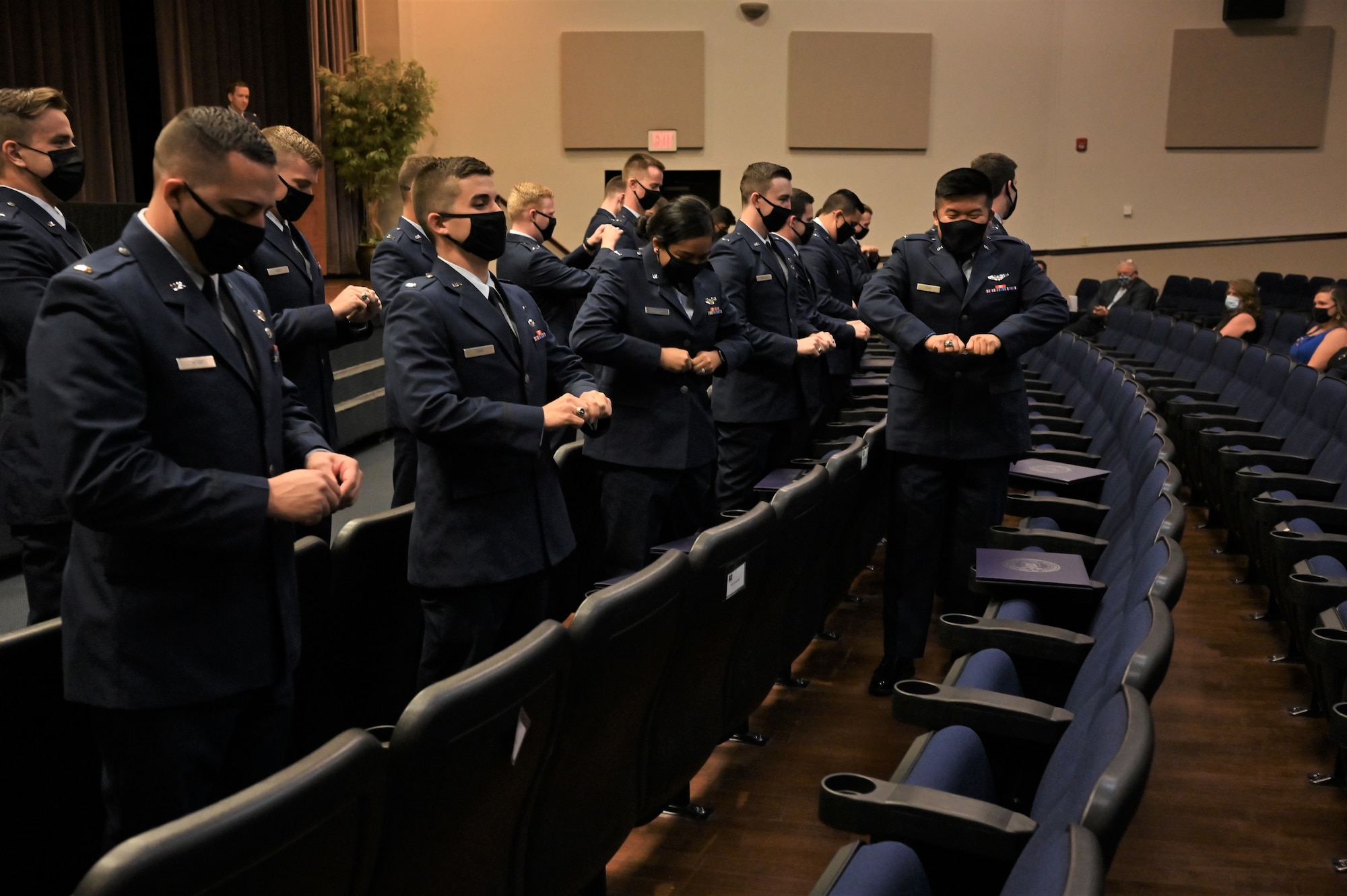 Graduates from Specialized Undergraduate Pilot Training class 21-15, break their first pair of wings during the graduation ceremony, Sept. 10, 2021, on Columbus Air Force Base, Miss. Per tradition, pilots will keep one half of the broken wings and give the second half to a loved one. The two halves are never to be brought back together while the pilot is still alive. (U.S. Air Force photo by Senior Airman Jake Jacobsen)