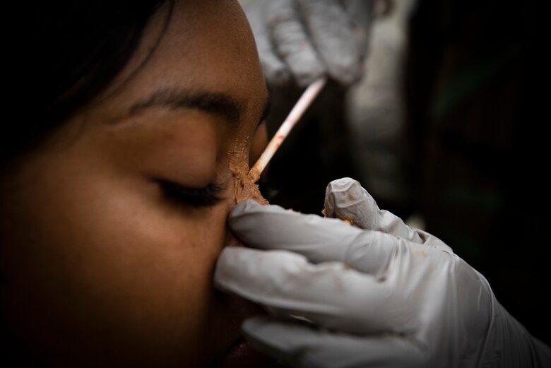 Senior Airman Shauna-Kay Nation has a broken nose moulaged onto her face prior to a training event at Osan Air Base