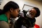 Senior Airman Kenyetta Oglesbe (right) applies broken nose moulage to Senior Airman Shauna-Kay Nation