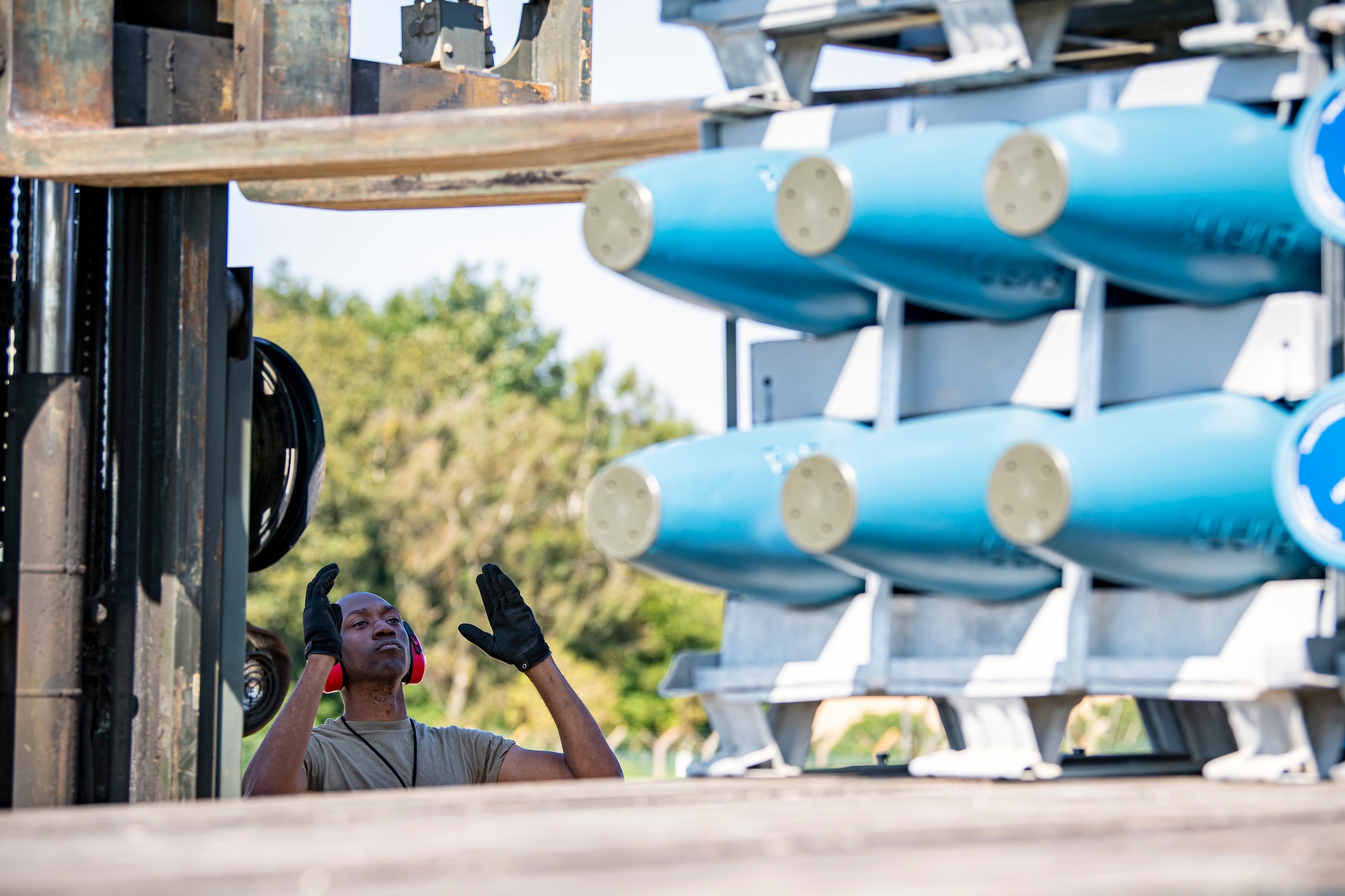 An Airman from the 420th Munitions Squadron directs the movement of inert assets during an asset transport at RAF Welford, England, Sept. 7, 2021. Airmen from the 420th MUNS transported multiple inert assets to RAF Lakenheath for an upcoming Agile Combat Employment exercise. (U.S. Air Force photo by Senior Airman Eugene Oliver)