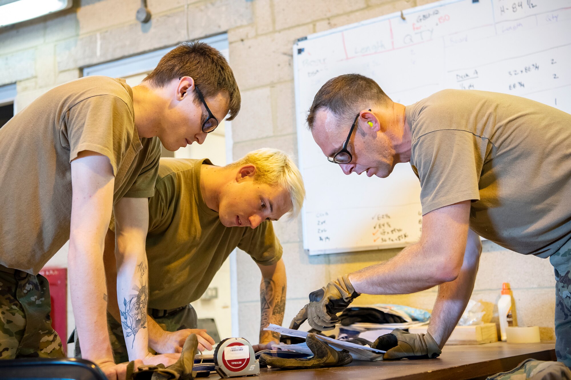 Airmen from the 420th Munitions Squadron, discuss strategy prior to an asset transport at RAF Welford, England, Sept. 7, 2021. Airmen from the 420th MUNS constructed multiple wooden structures and supports to help stabilize inert assets to be transported to RAF Lakenheath for an upcoming Agile Combat Employment exercise. (U.S. Air Force photo by Senior Airman Eugene Oliver)