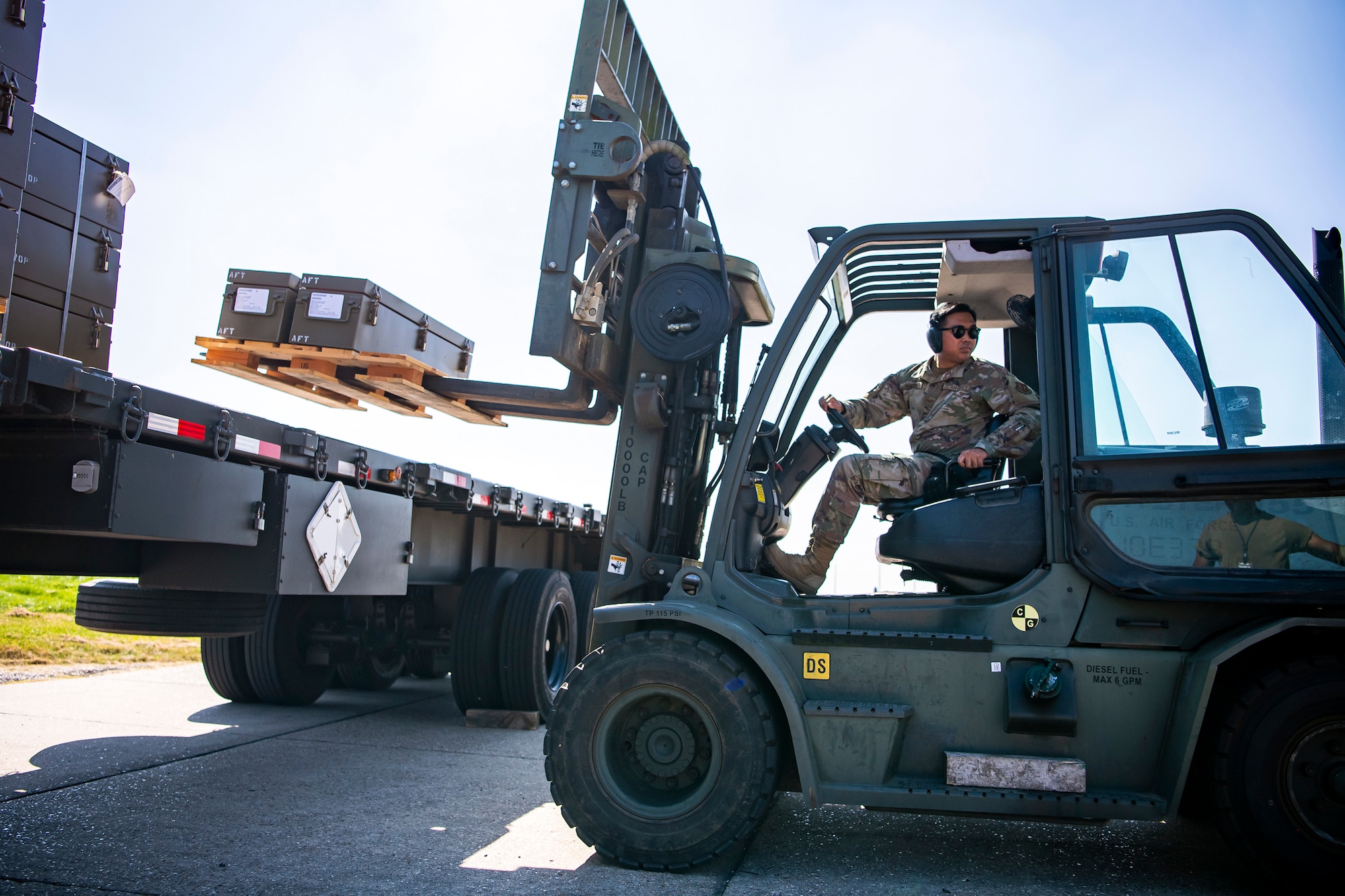 U.S. Air Force Senior Airman Von Mangaya, 420th Munitions Squadron stock pile technician, utilizes a forklift to move inert assets at RAF Welford, England, Sept. 7, 2021. Airmen from the 420th MUNS transported multiple inert assets to RAF Lakenheath for an upcoming Agile Combat Employment exercise. (U.S. Air Force photo by Senior Airman Eugene Oliver)