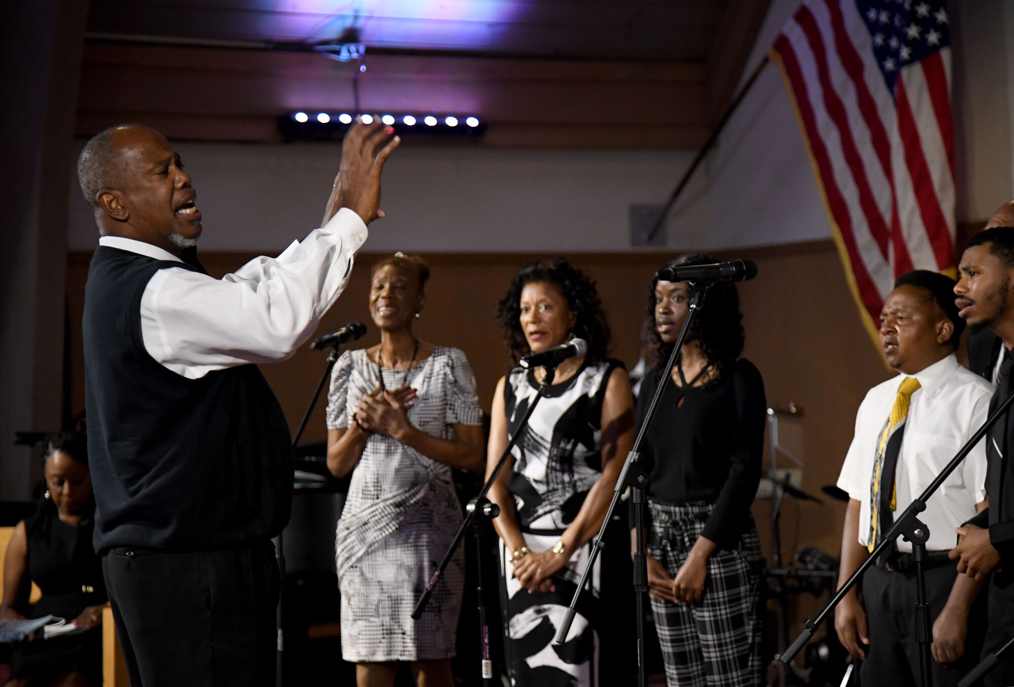 Minister Dennis Thompson leads the Gospel Choir in a song during the 50th Gospel Worship Service Anniversary inside Larcher Chapel at Keesler Air Force Base, Mississippi, Sept. 12, 2021. The service's theme was “Growing Stronger, Growing Deeper, Reaching Higher." (U.S. Air Force photo by Kemberly Groue)