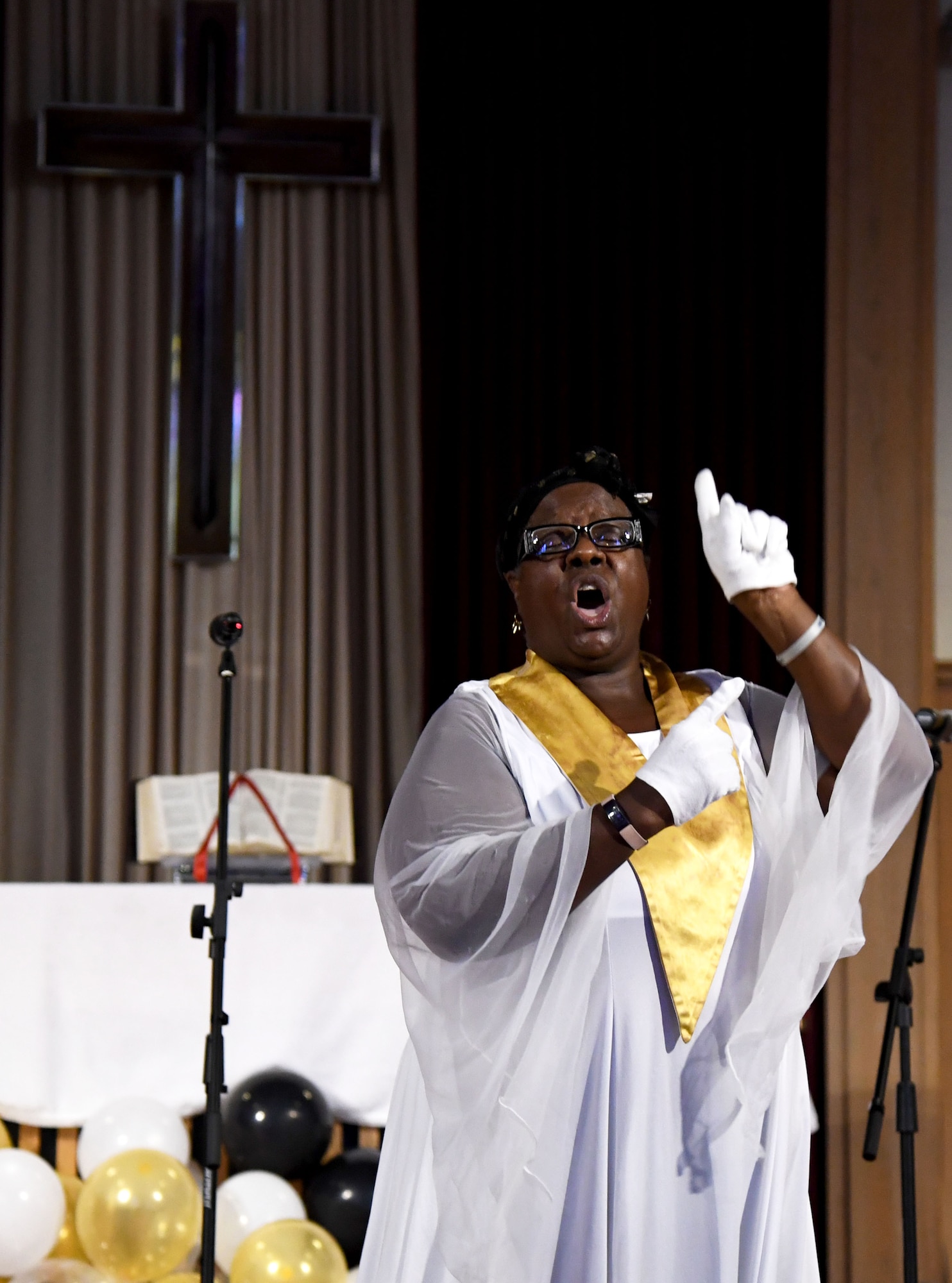 Carla Heard, Gospel Choir member, performs a ministry song in sign language during the 50th Gospel Worship Service Anniversary inside Larcher Chapel at Keesler Air Force Base, Mississippi, Sept. 12, 2021. The service's theme was “Growing Stronger, Growing Deeper, Reaching Higher." (U.S. Air Force photo by Kemberly Groue)