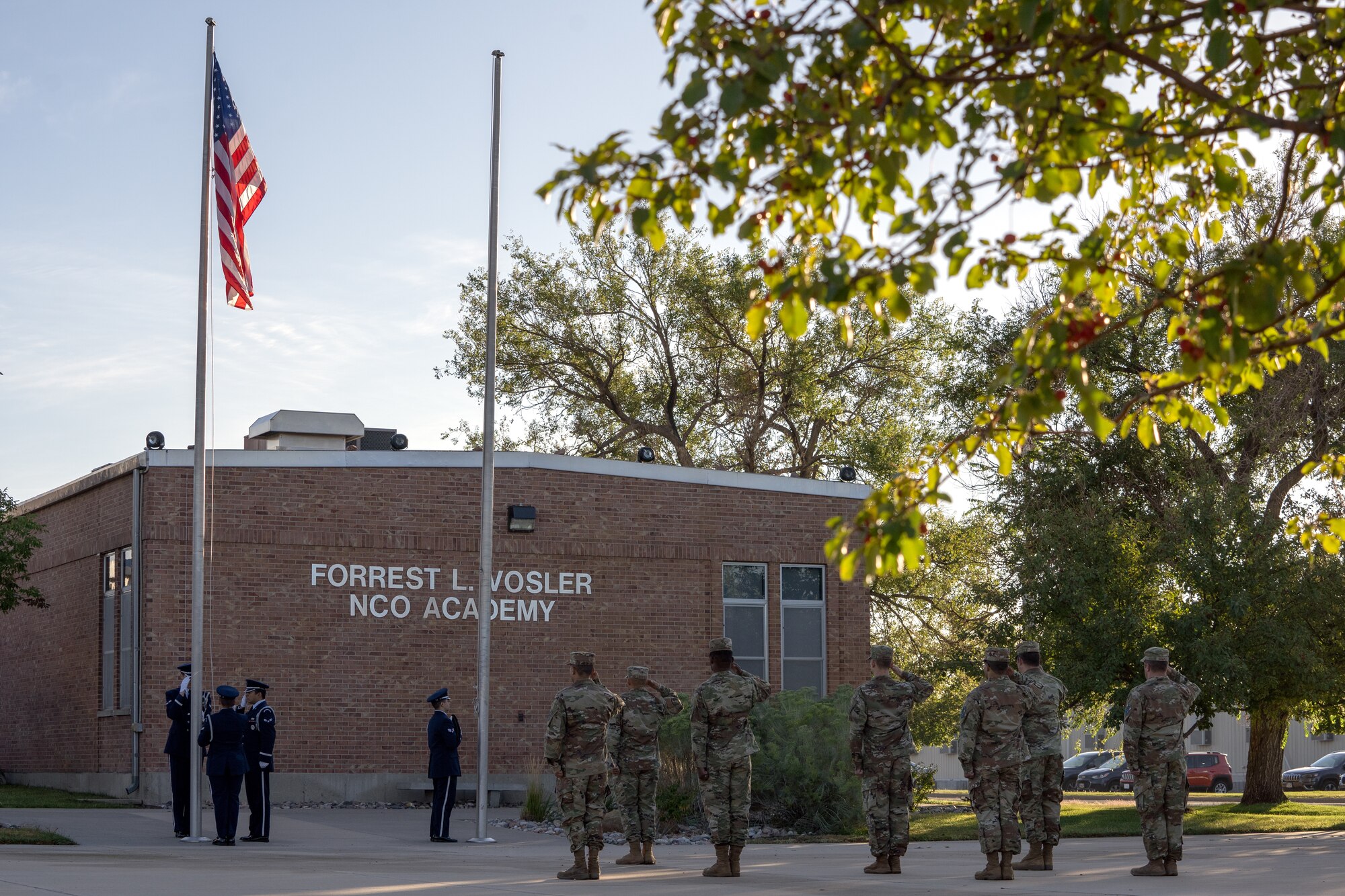 High Frontier Honor Guard Ceremonial Guardsman and Peterson-Schriever Garrison personnel salute the American flag.