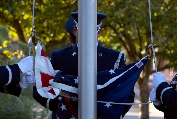 High Frontier Honor Guard Ceremonial Guardsman attach the American flag to the flag pole.