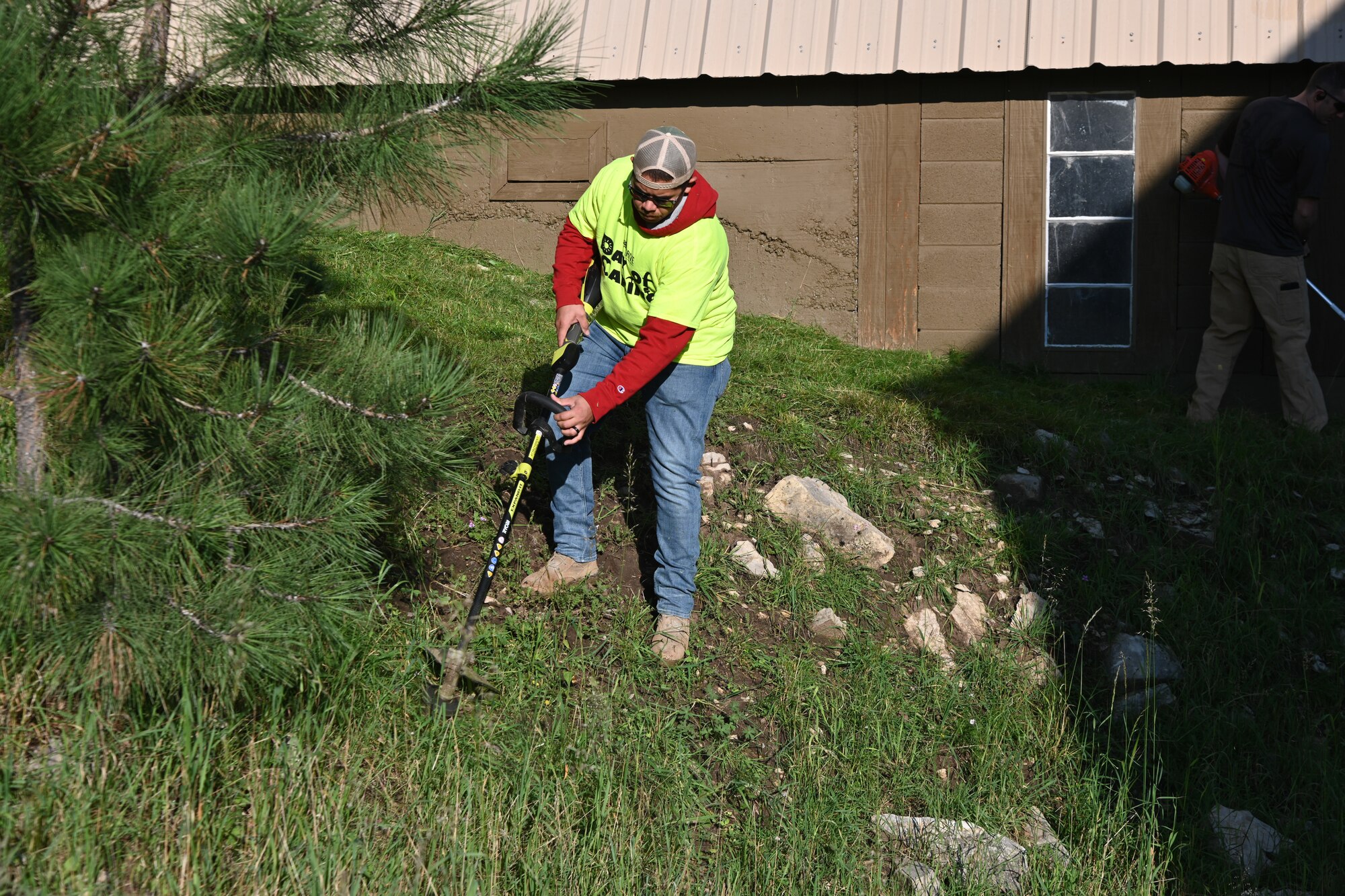 Airman 1st Class Celestino Lopez, Day of Caring volunteer from Holloman Air Force Base, New Mexico, cuts the grass during the 30th annual Day of Caring, Sept. 10, 2021, in Cloudcroft, New Mexico. Day of Caring volunteers perform a variety of tasks from lawn mowing to painting houses for community members in need. (U.S. Air Force Photo by Airman 1st Class Jessica Sanchez-Chen)