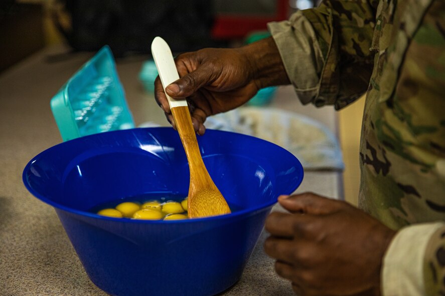 Lt. Col. Dwane Jones, Task Force-Holloman chaplain, prepares breakfast for the Airmen working at Aman Omid Village in Holloman Air Force Base, New Mexico on Sept. 13, 2021. The Department of Defense, through U.S. Northern Command, and in support of the Department of State and Department of Homeland Security, is providing transportation, temporary housing, medical screening, and general support for at least 50,000 Afghan evacuees at suitable facilities, in permanent or temporary structures, as quickly as possible. This initiative provides Afghan evacuees essential support at secure locations outside Afghanistan.(U.S. Army photo by Pfc. Anthony Sanchez)