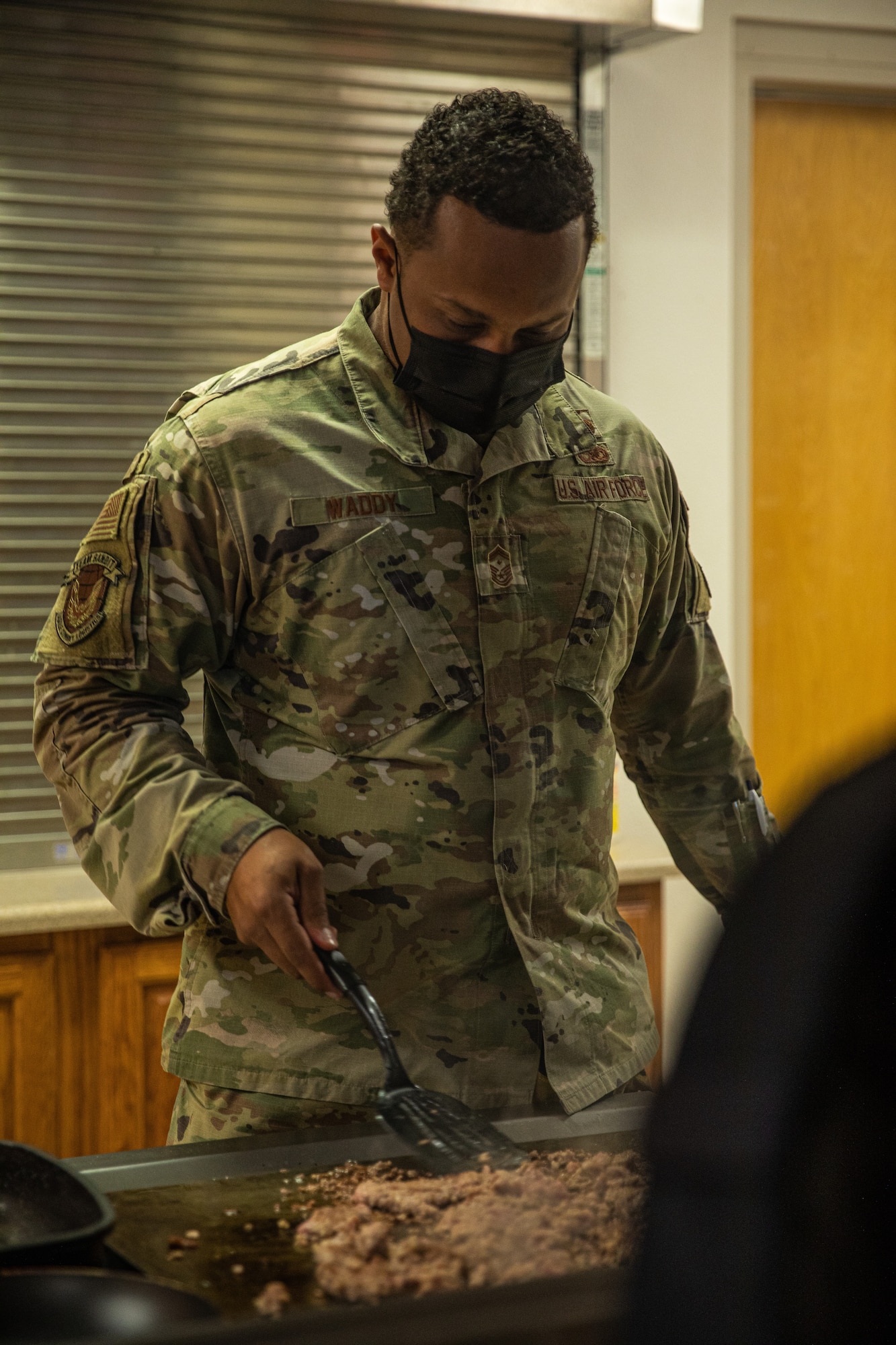 Senior Master Sgt. Aaron Waddy, Task Force-Holloman first sergeant, prepares breakfast for the Airmen working at Aman Omid Village in Holloman Air Force Base, New Mexico on Sept. 13, 2021. The Department of Defense, through U.S. Northern Command, and in support of the Department of State and Department of Homeland Security, is providing transportation, temporary housing, medical screening, and general support for at least 50,000 Afghan evacuees at suitable facilities, in permanent or temporary structures, as quickly as possible. This initiative provides Afghan evacuees essential support at secure locations outside Afghanistan. (U.S. Army photo by Pfc. Anthony Sanchez)