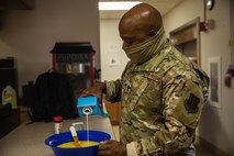 Lt. Col. Dwane Jones, Task Force-Holloman chaplain, prepares breakfast for the Airmen working at Aman Omid Village in Holloman Air Force Base, New Mexico on Sept. 13, 2021. The Department of Defense, through U.S. Northern Command, and in support of the Department of State and Department of Homeland Security, is providing transportation, temporary housing, medical screening, and general support for at least 50,000 Afghan evacuees at suitable facilities, in permanent or temporary structures, as quickly as possible. This initiative provides Afghan evacuees essential support at secure locations outside Afghanistan.(U.S. Army photo by Pfc. Anthony Sanchez)