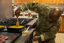 Lt. Col. Dwane Jones, Task Force-Holloman chaplain, prepares breakfast for the Airmen working at Aman Omid Village in Holloman Air Force Base, New Mexico on Sept. 13, 2021. The Department of Defense, through U.S. Northern Command, and in support of the Department of State and Department of Homeland Security, is providing transportation, temporary housing, medical screening, and general support for at least 50,000 Afghan evacuees at suitable facilities, in permanent or temporary structures, as quickly as possible. This initiative provides Afghan evacuees essential support at secure locations outside Afghanistan.(U.S. Army photo by Pfc. Anthony Sanchez)
