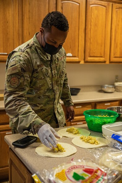 Senior Master Sgt. Aaron Waddy, Task Force-Holloman first sergeant, prepares breakfast for the Airmen working at Aman Omid Village in Holloman Air Force Base, New Mexico on Sept. 13, 2021. The Department of Defense, through U.S. Northern Command, and in support of the Department of State and Department of Homeland Security, is providing transportation, temporary housing, medical screening, and general support for at least 50,000 Afghan evacuees at suitable facilities, in permanent or temporary structures, as quickly as possible. This initiative provides Afghan evacuees essential support at secure locations outside Afghanistan. (U.S. Army photo by Pfc. Anthony Sanchez)